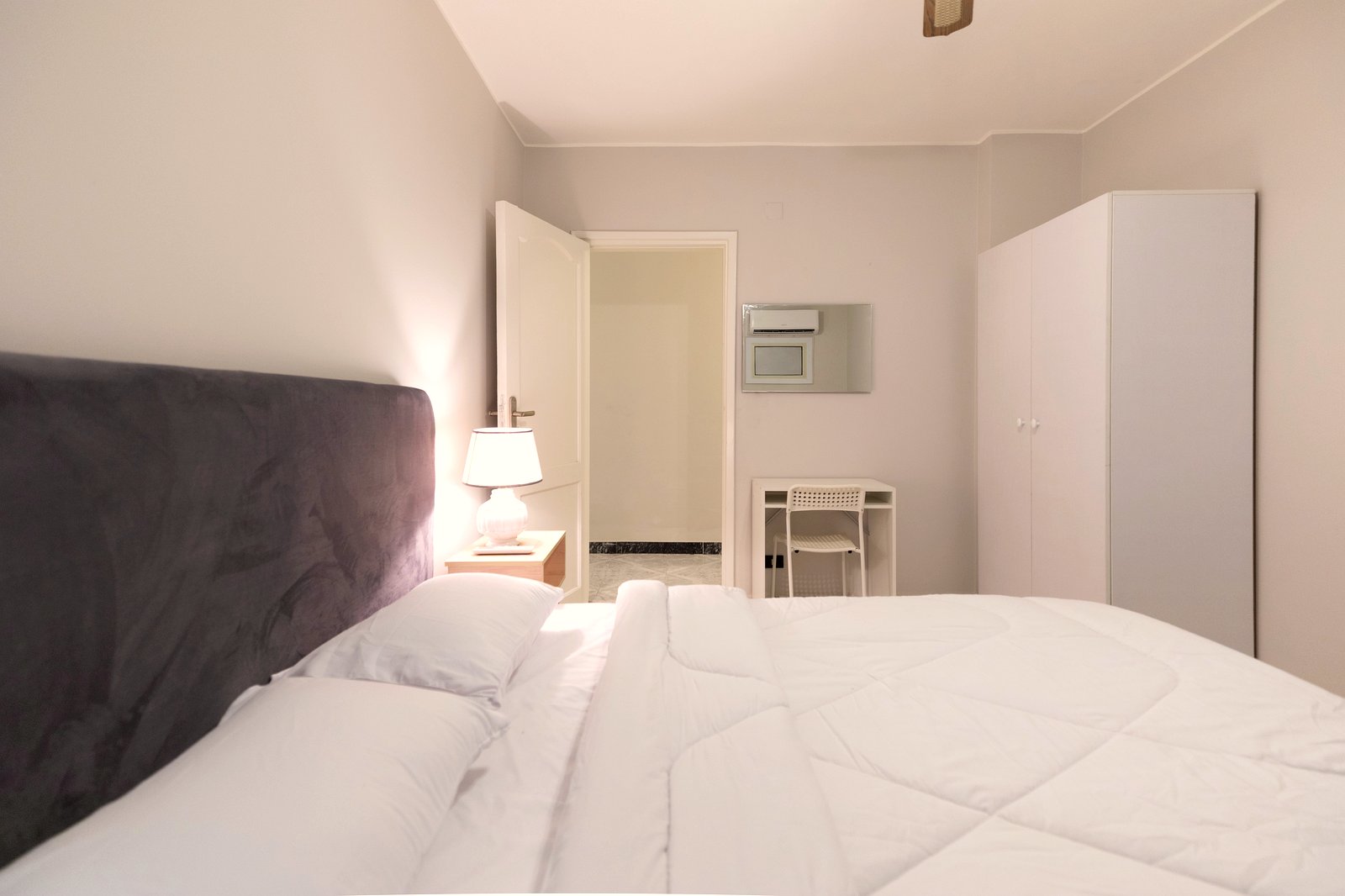 Furnished bedroom with soft natural light